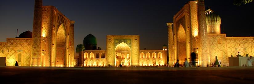 Traditional buildings lit up at night in Samarkand