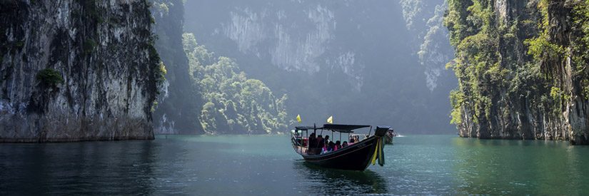 Boat passing in between islands in Thailand