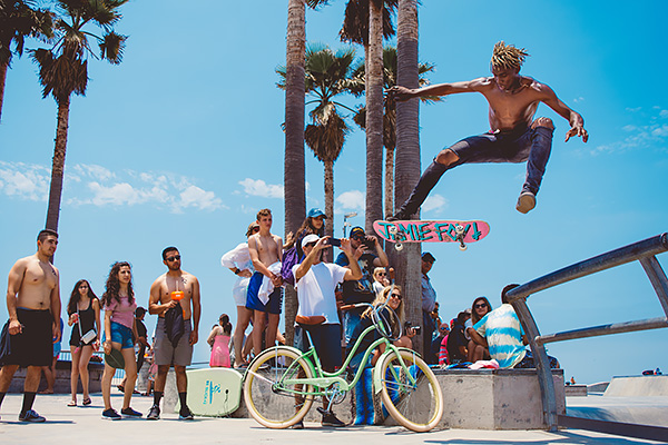 Man doing a skateboarding trick at Venice Beach, LA